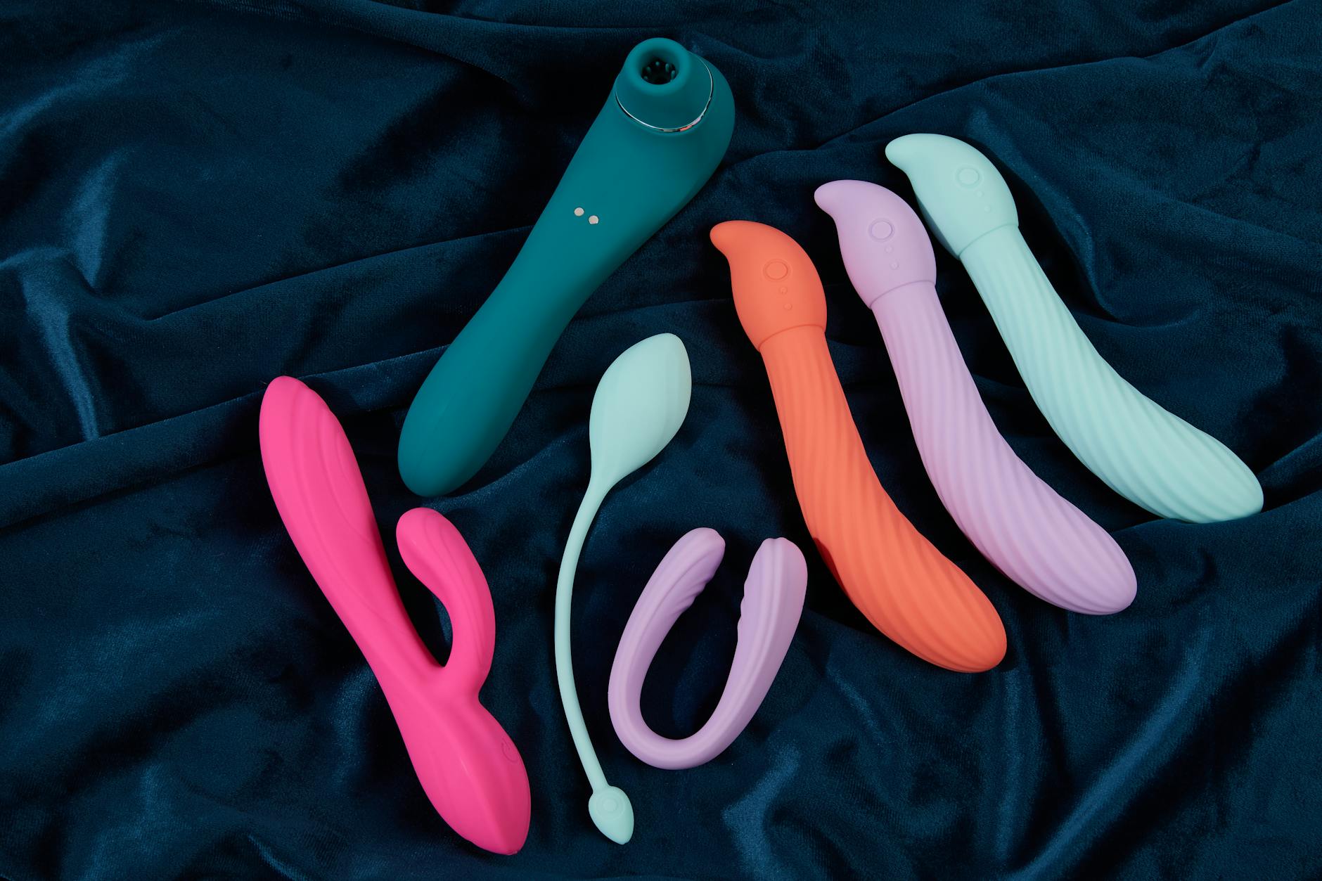 Hand holding a vibrator against a minimalist backdrop, symbolizing sensual recovery